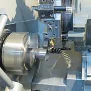 Moderne CNC-Drehmaschine beim Bearbeiten eines Metallteils mit hoher Präzision.