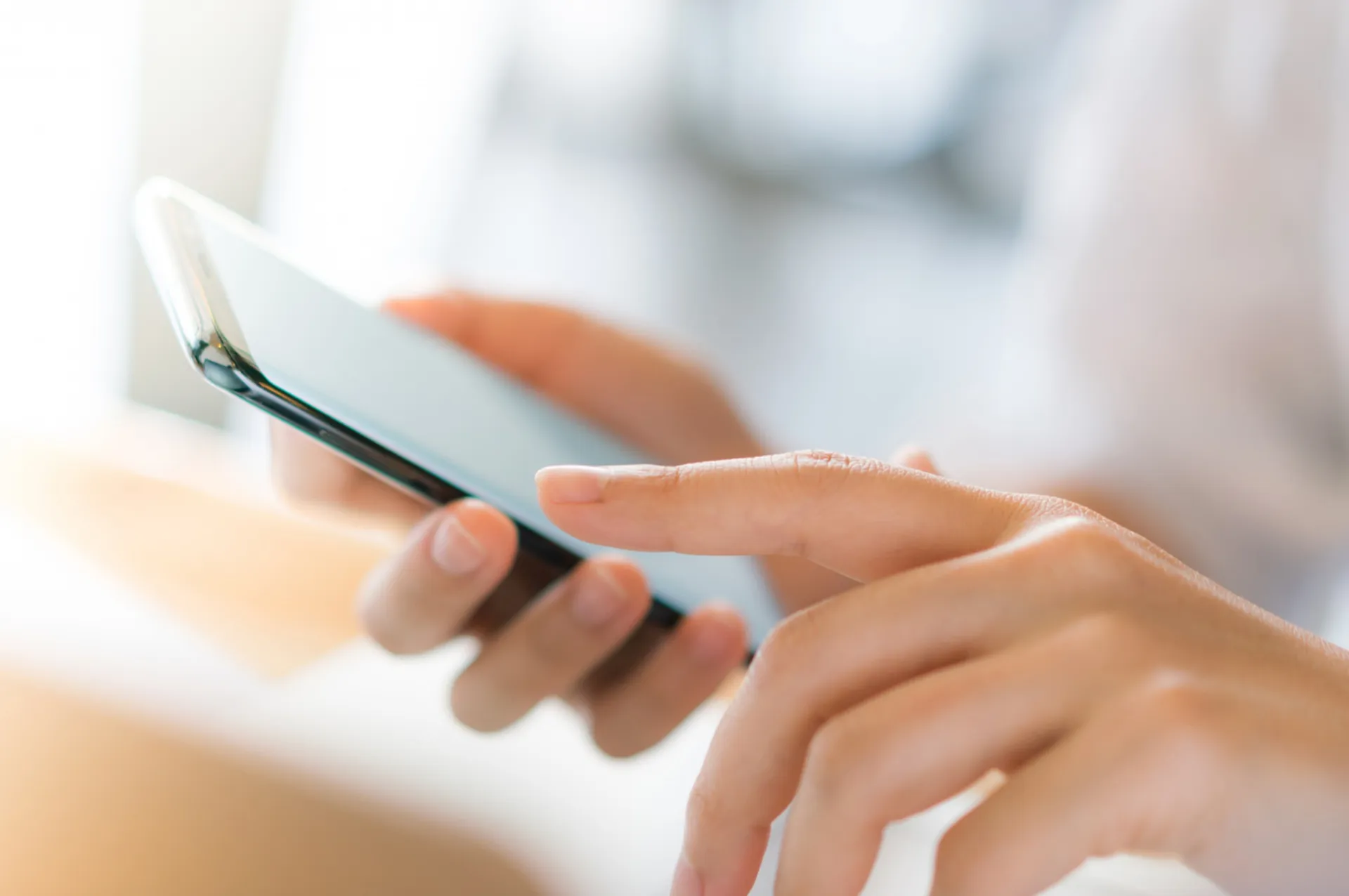 Person tippt auf Smartphone, einfache und schnelle Kontaktaufnahme mit Zeidler & Uhl.